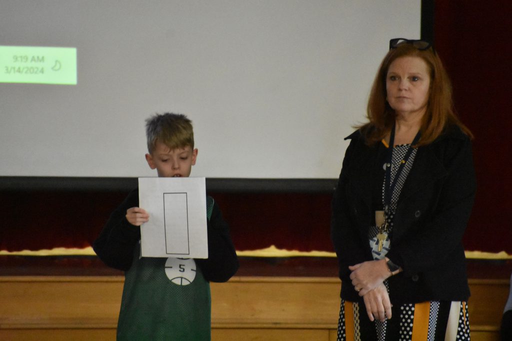 Jennifer Olds and student speaking at assembly