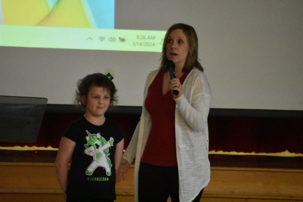 Author Melanie Lopata and Herkimer student speaking at assembly
