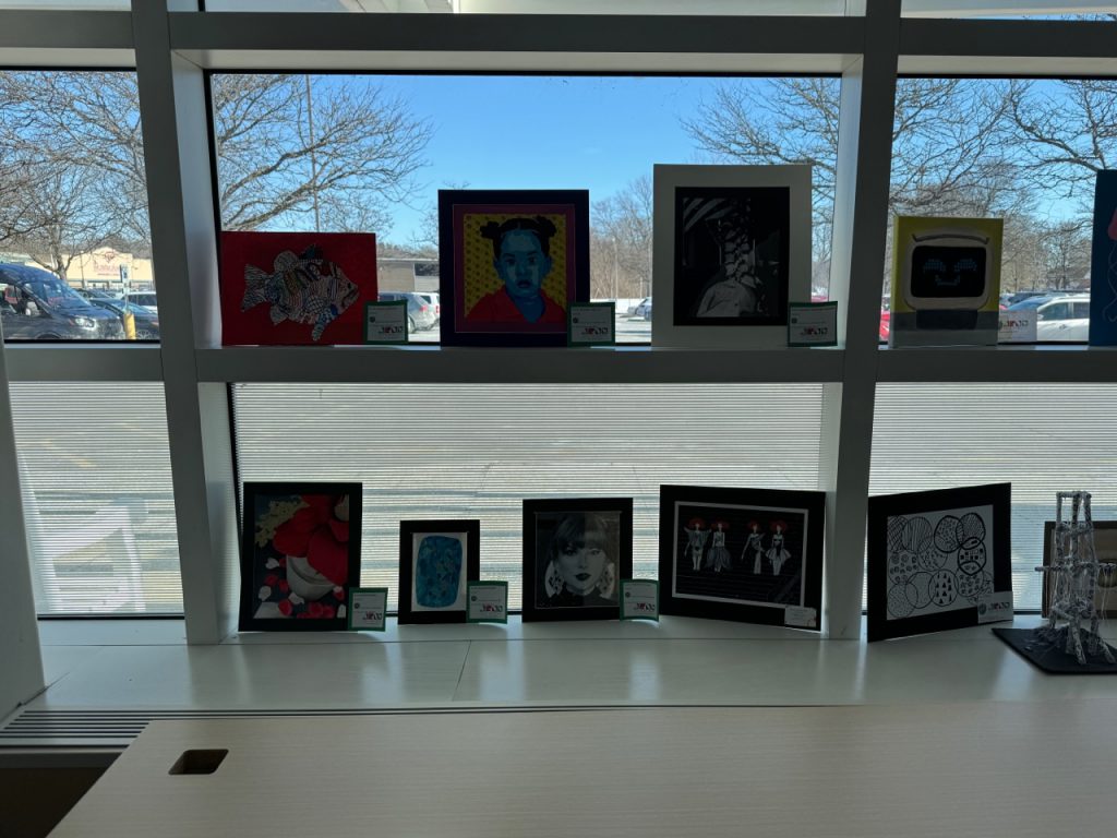 More Herkimer student artwork in front of a window
