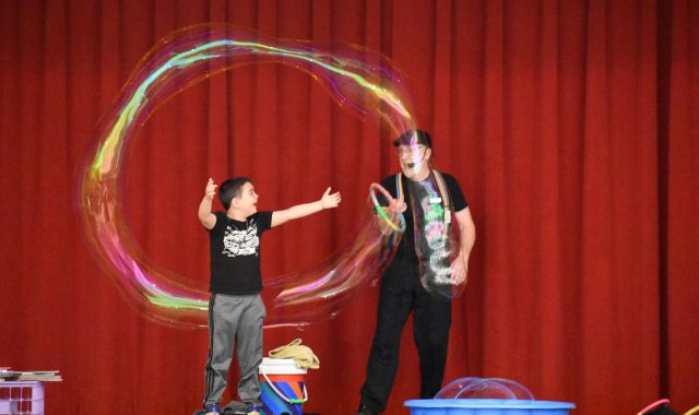 Guest speaker makes a large bubble behind student