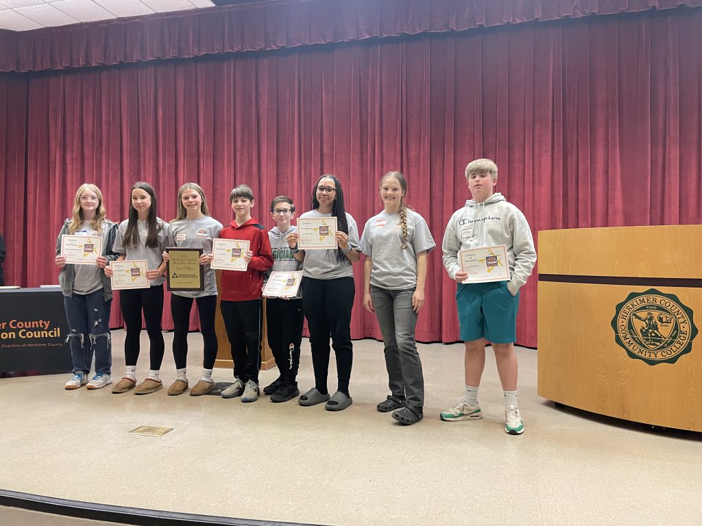 Herkimer Drug Quiz team members on stage at Herkimer College