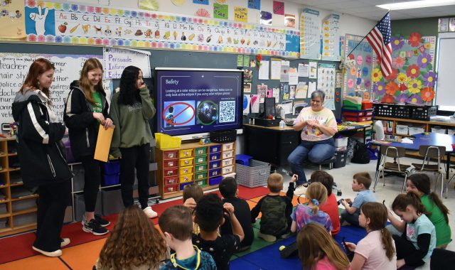 Three Jr./Sr. High School students present to elementary students about the eclipse
