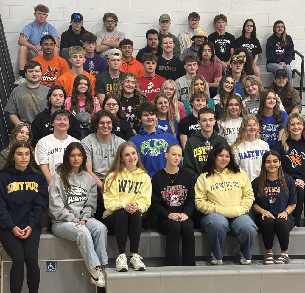 Herkimer Class of 2025 seniors wearing clothing representing their college, military or career choices.