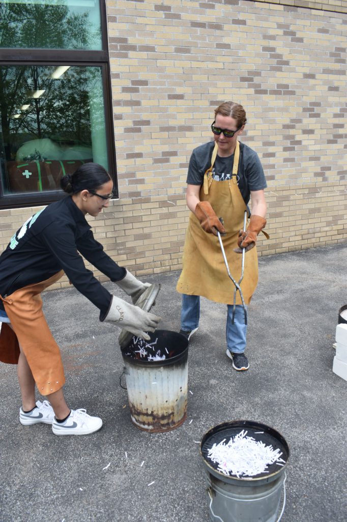 Student and an art teacher working during Raku firing workshop