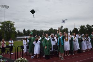Graduates throw their caps in the air