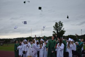 Graduates throw their caps in the air