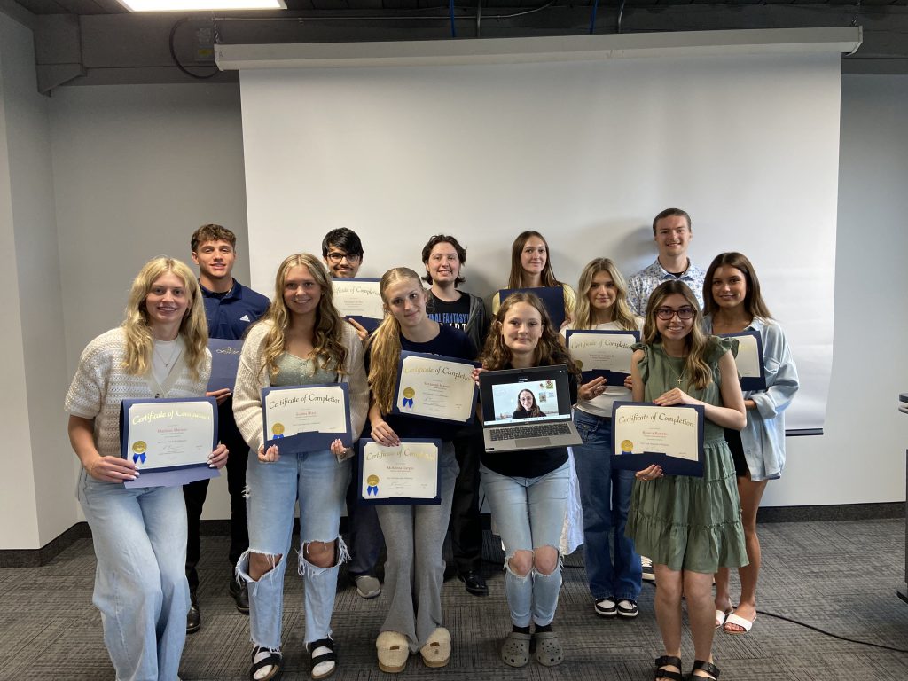 Students pose with their seal of biliteracy certificates