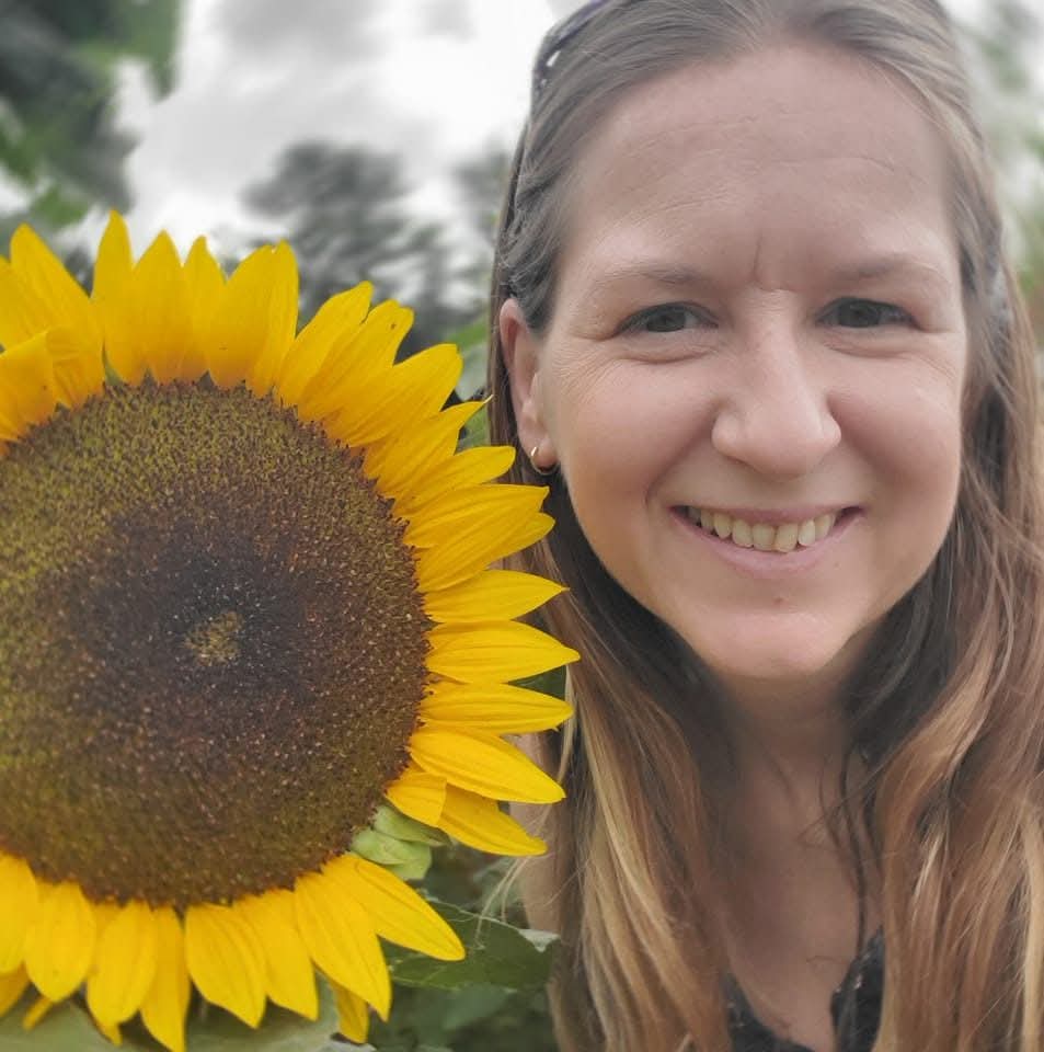 Angie Carnright with a sunflower