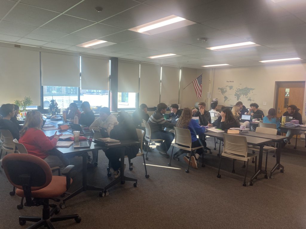 Students at desks in class for mock congress activity
