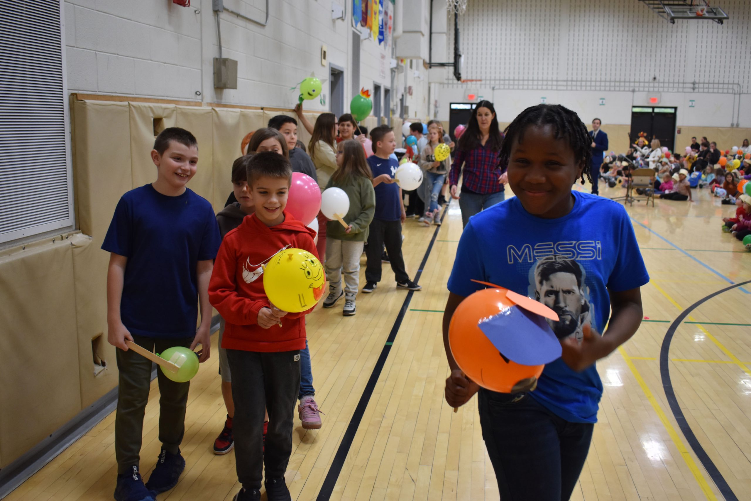 Students in balloon parade at assembly