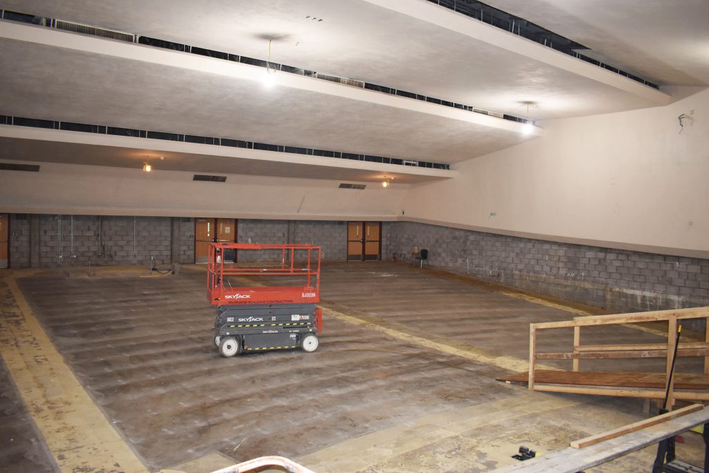 View from the stage out to the empty seating area during auditorium renovation