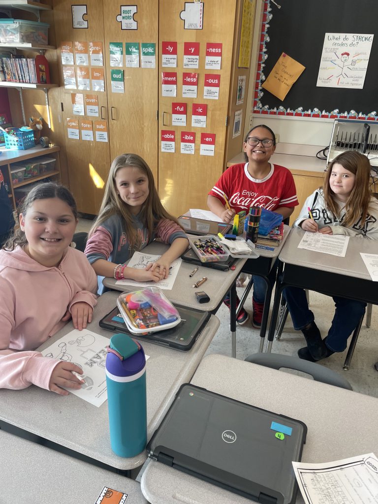 Four students at desks