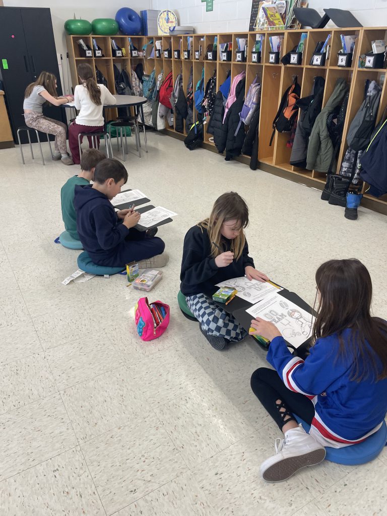 Students sitting on the floor working