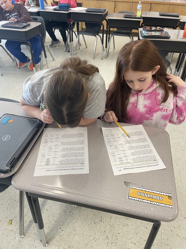 Two students working together at desk