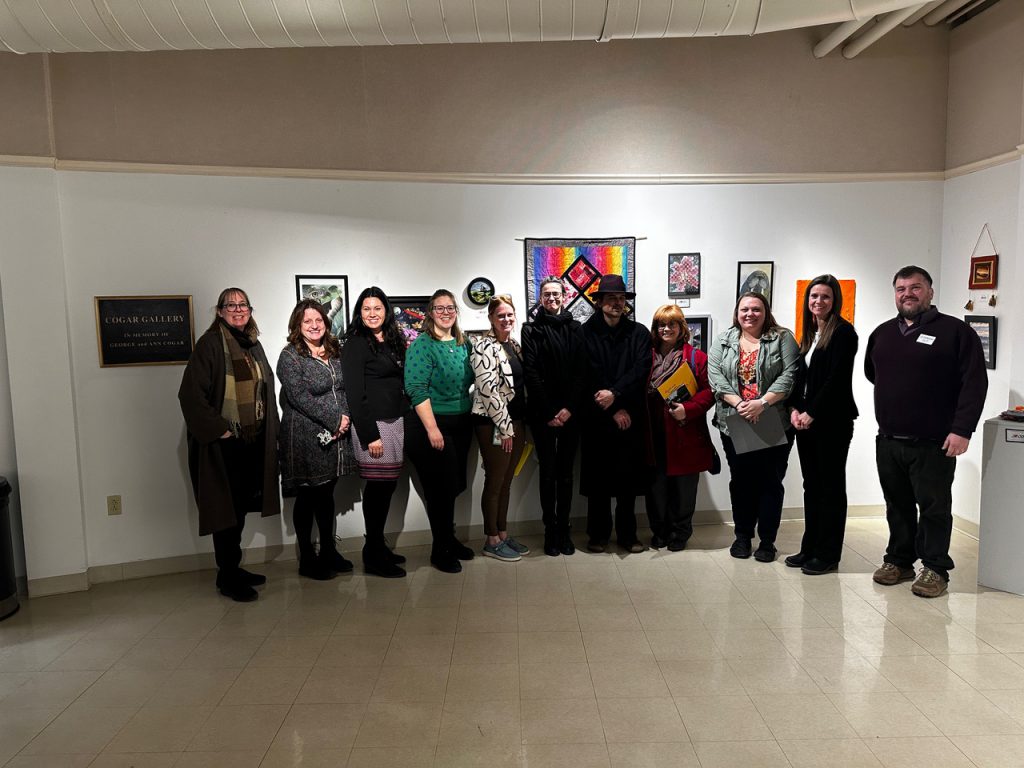 Local art teachers posing at art exhibit