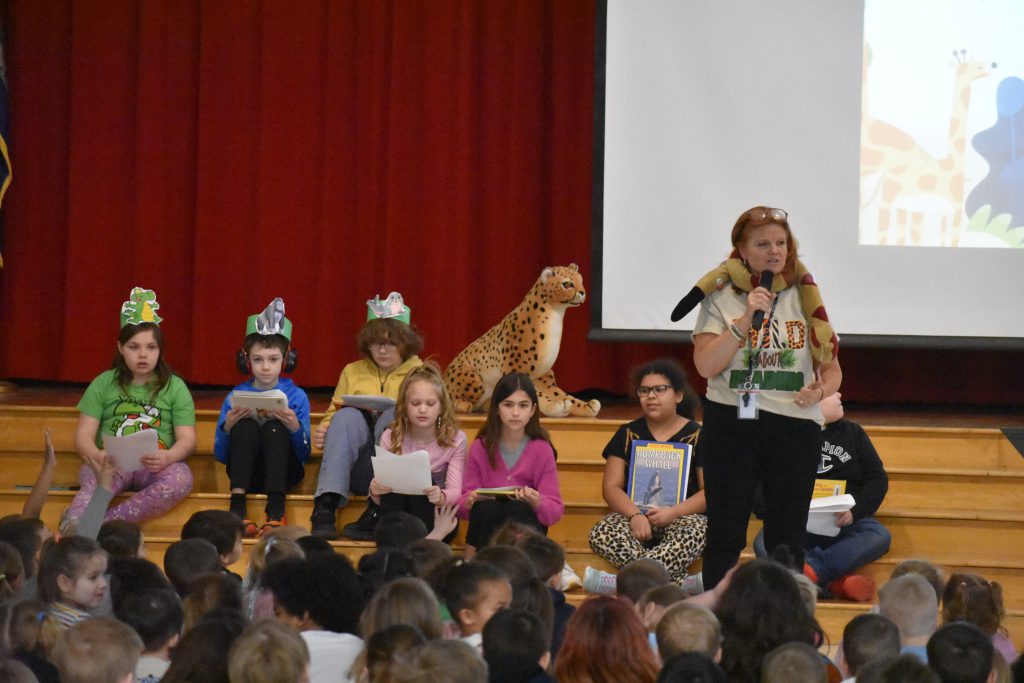 4th Grade Library Club and Library Media Specialist Jennifer Olds on stage during assembly