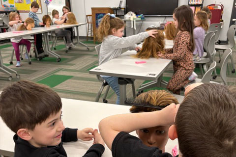 Students working with mannequin heads for project
