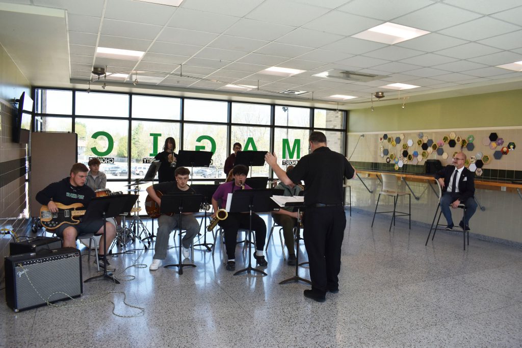 Senator watching as Jazz Band performs in upstairs lobby