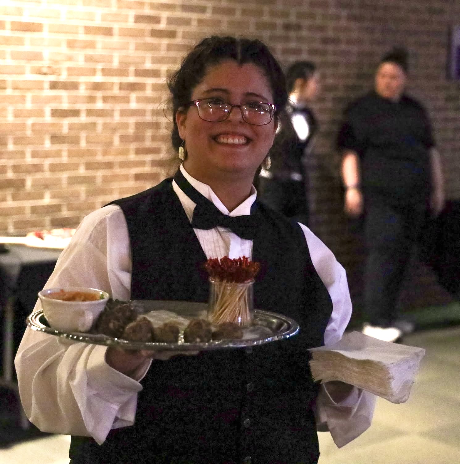 Alana Schlappi holding a tray of meatballs at Herkimer BOCES