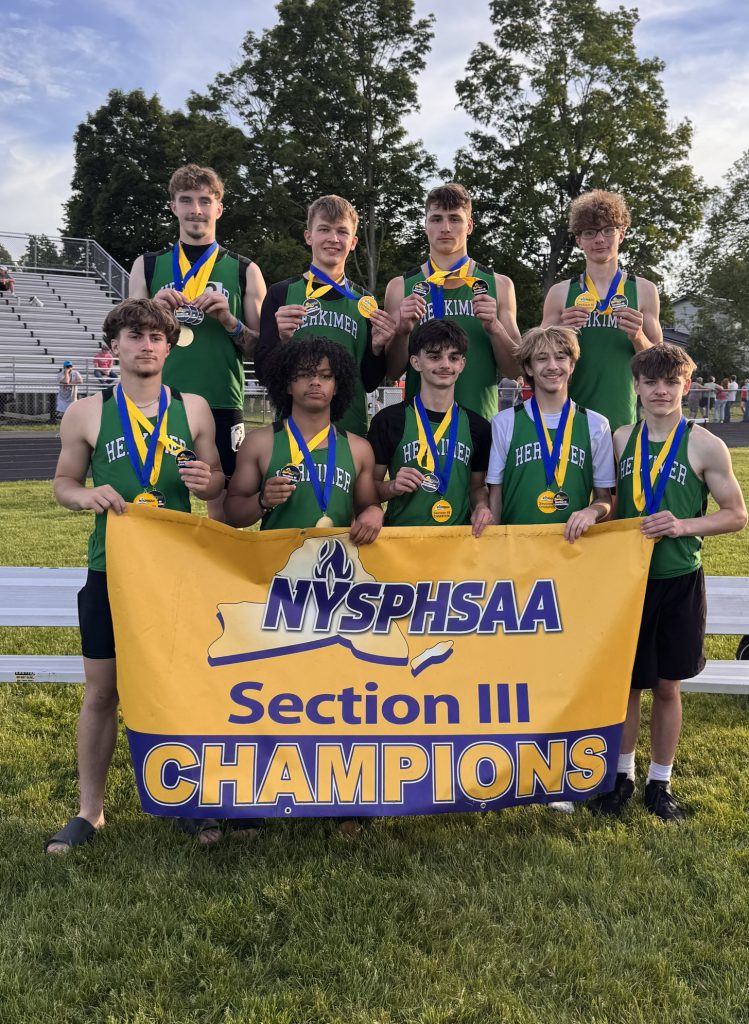 Individual and relay winners with sectional championship banner and their medals