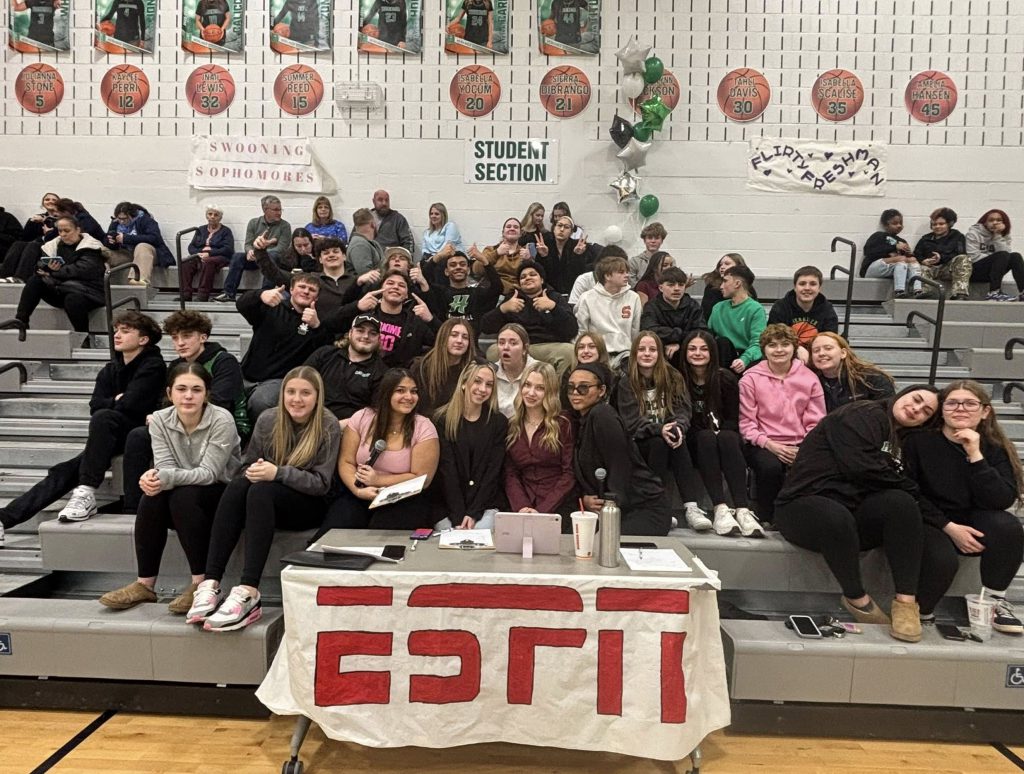 Student section at basketball game with ESPN banner