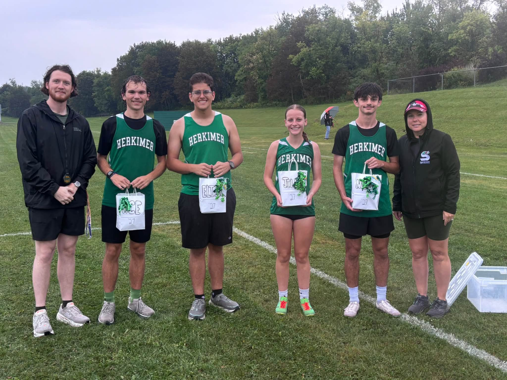 Cross Country seniors and coaches posing together outside