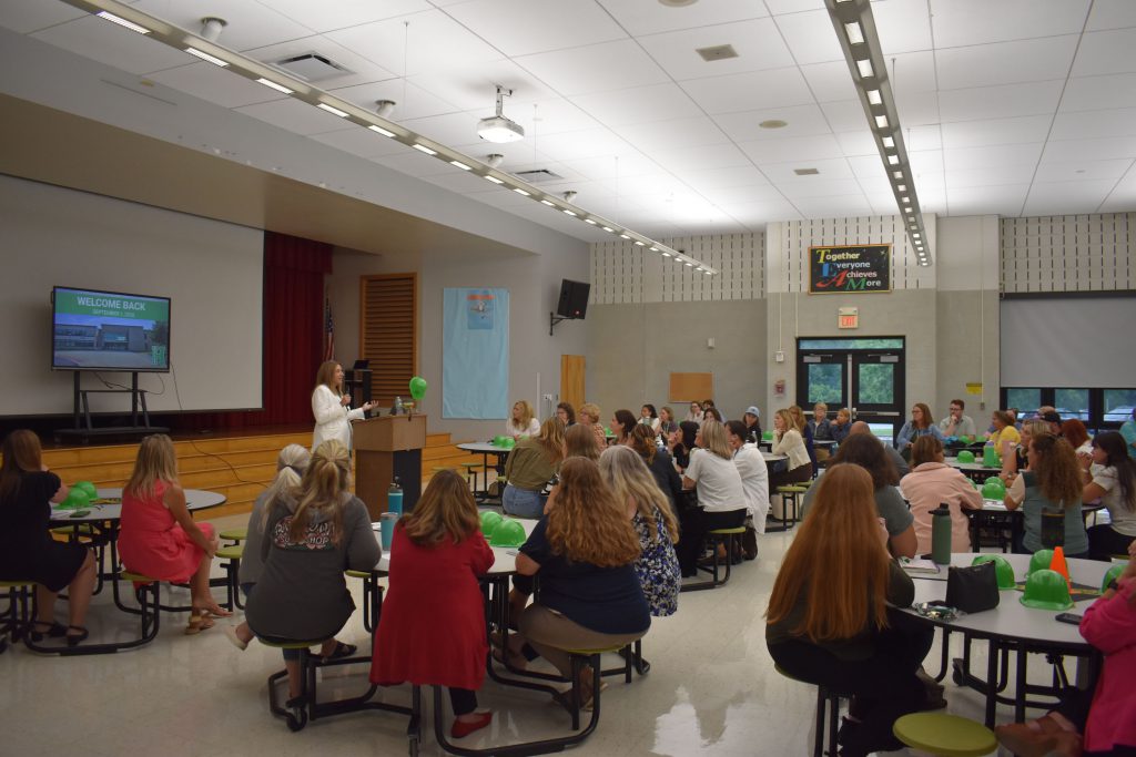 Herkimer Superintendent Kathleen Carney presenting as staff look on in the Elementary Cafetorium