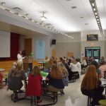 Superintendent speaking to staff in cafetorium