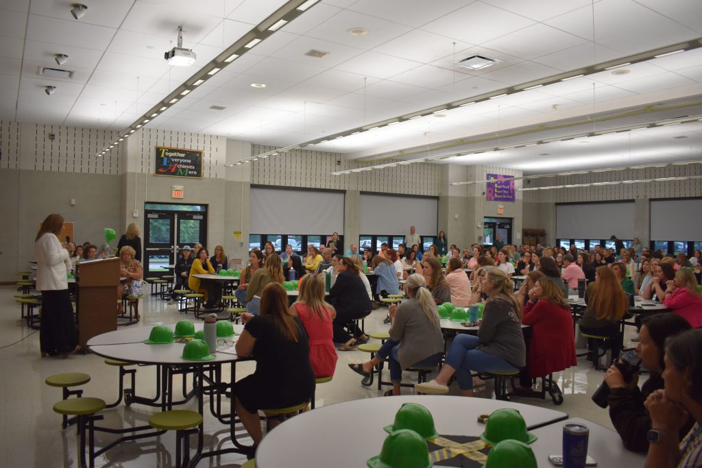 Herkimer Superintendent Kathleen Carney presenting as staff look on in the Elementary Cafetorium