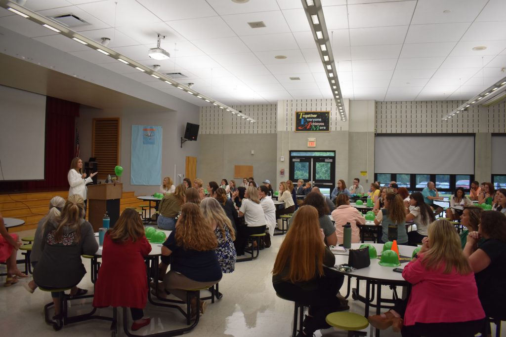 Herkimer Superintendent Kathleen Carney presenting as staff look on in the Elementary Cafetorium