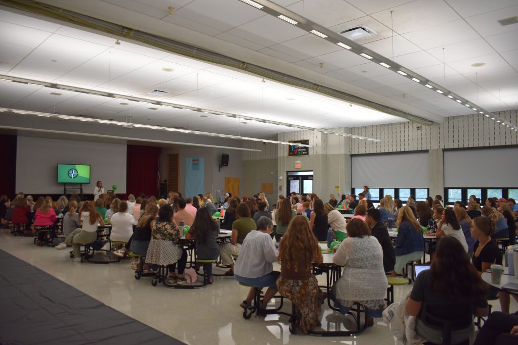 Herkimer Superintendent Kathleen Carney presenting as staff look on in the Elementary Cafetorium