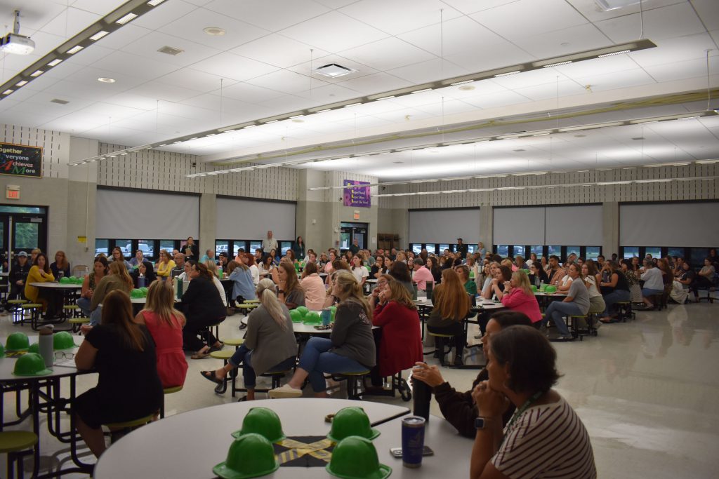Staff sitting at tables in the Elementary Cafetorium