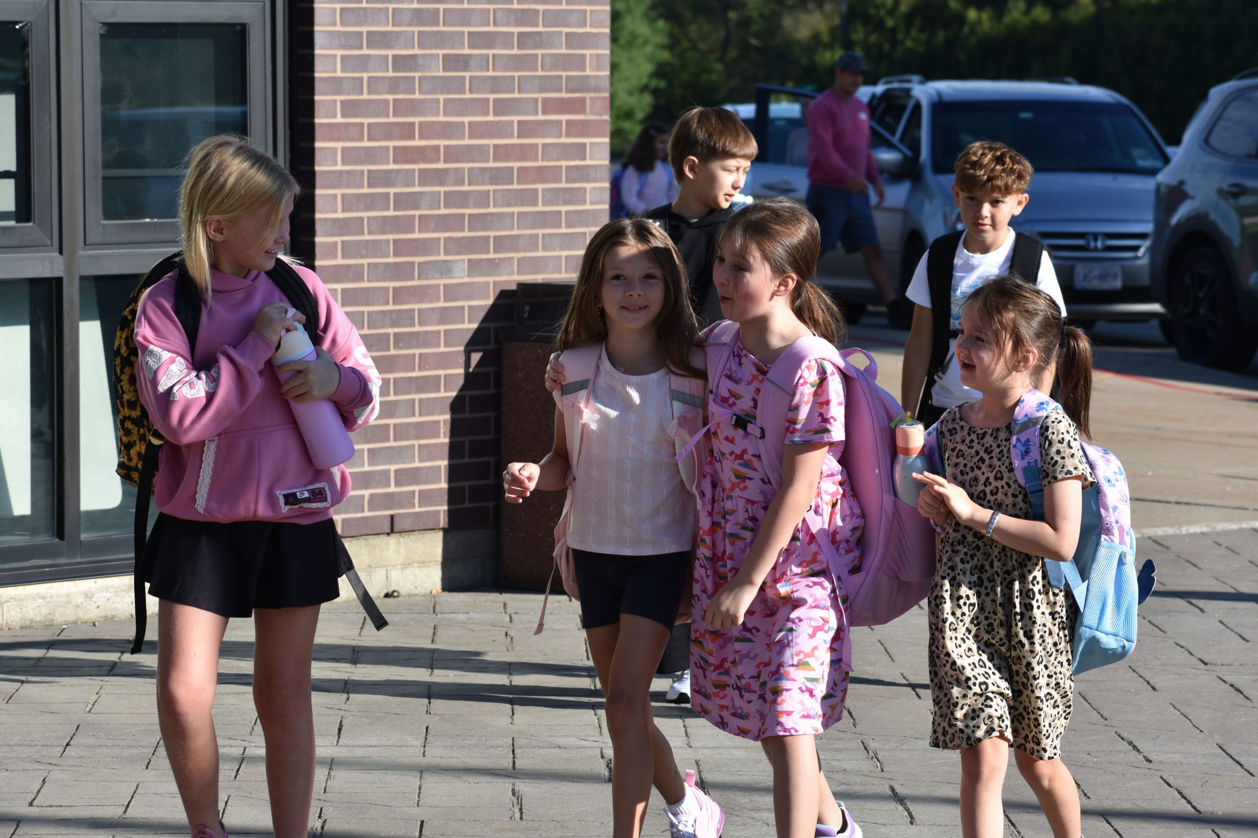 Students walking outside toward the school on the fist day of school