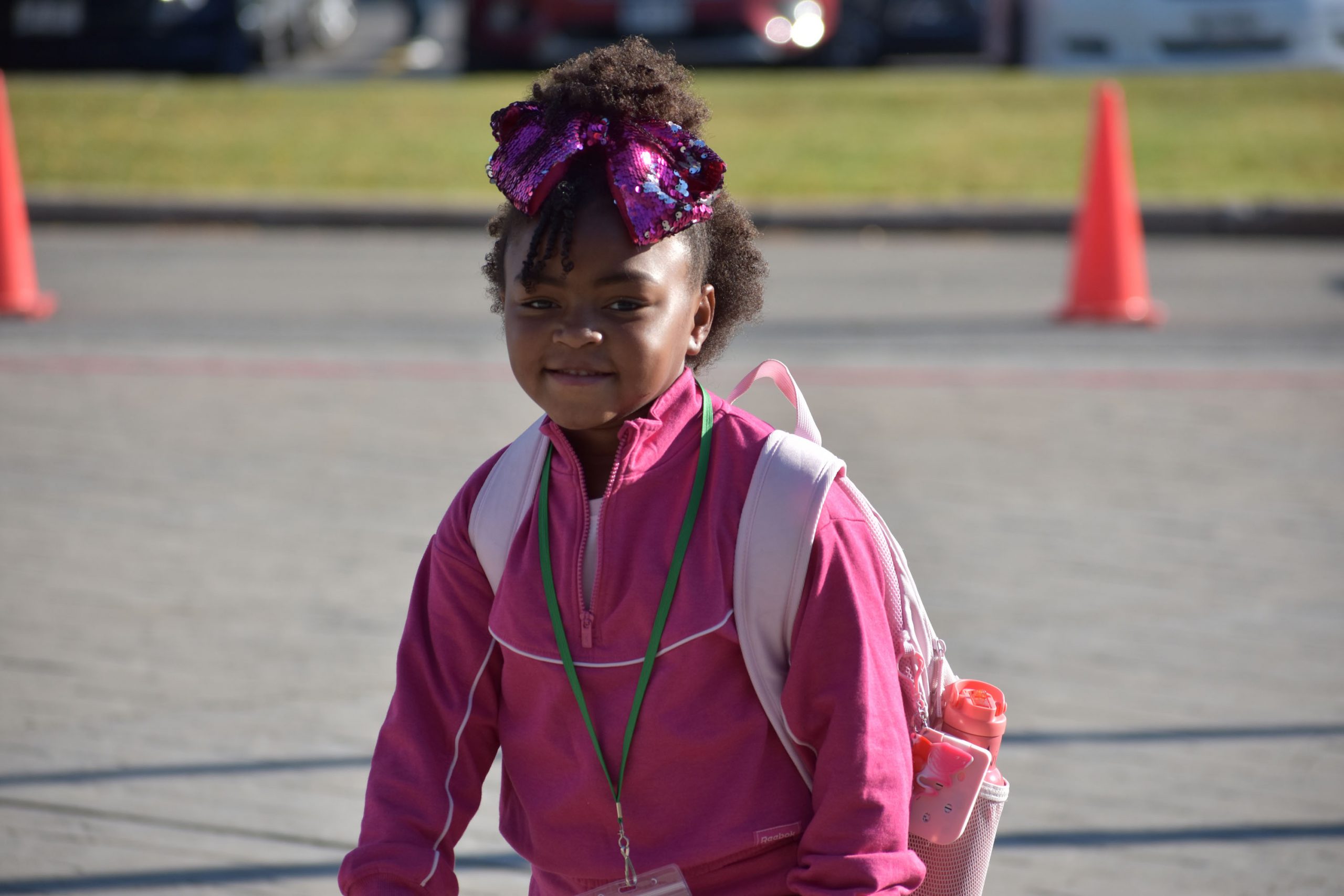 Student outside walking toward school on first day of school