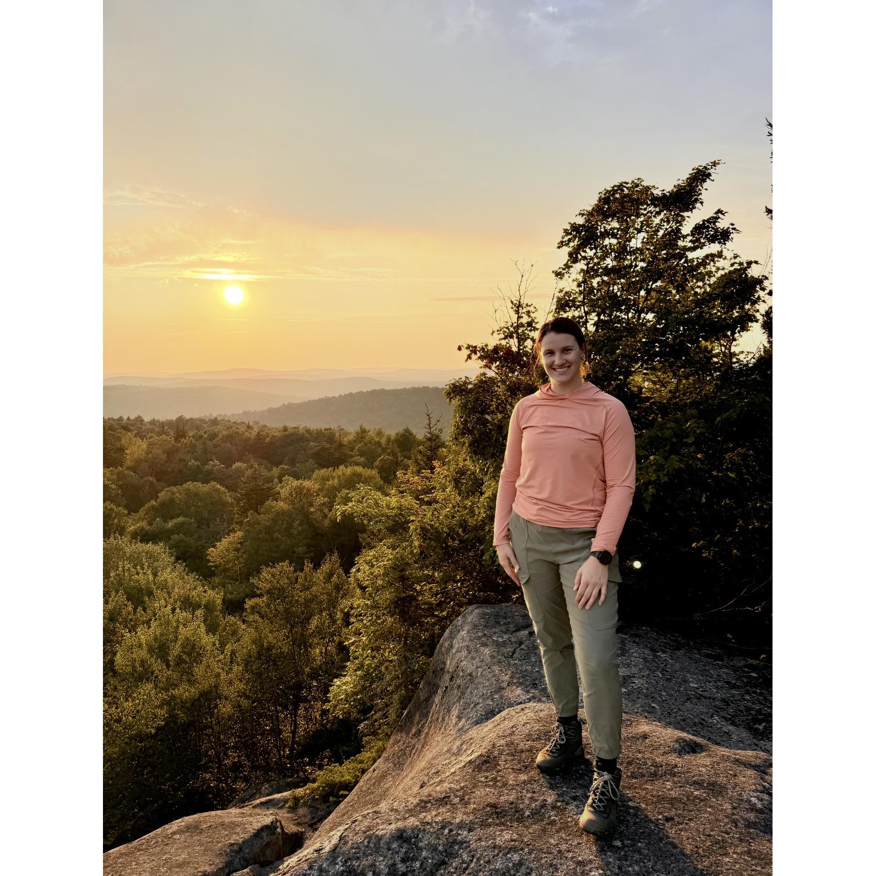 Anna Shelley outside in front of scenery of trees and the sky