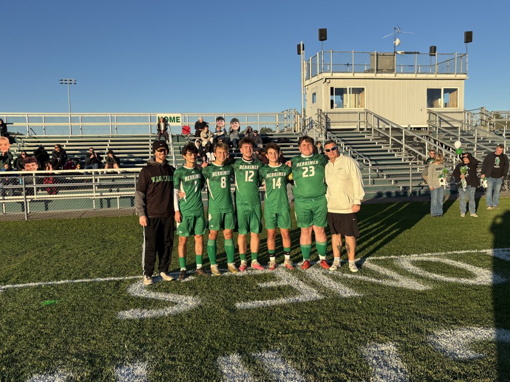 Boys varsity soccer seniors with two coaches