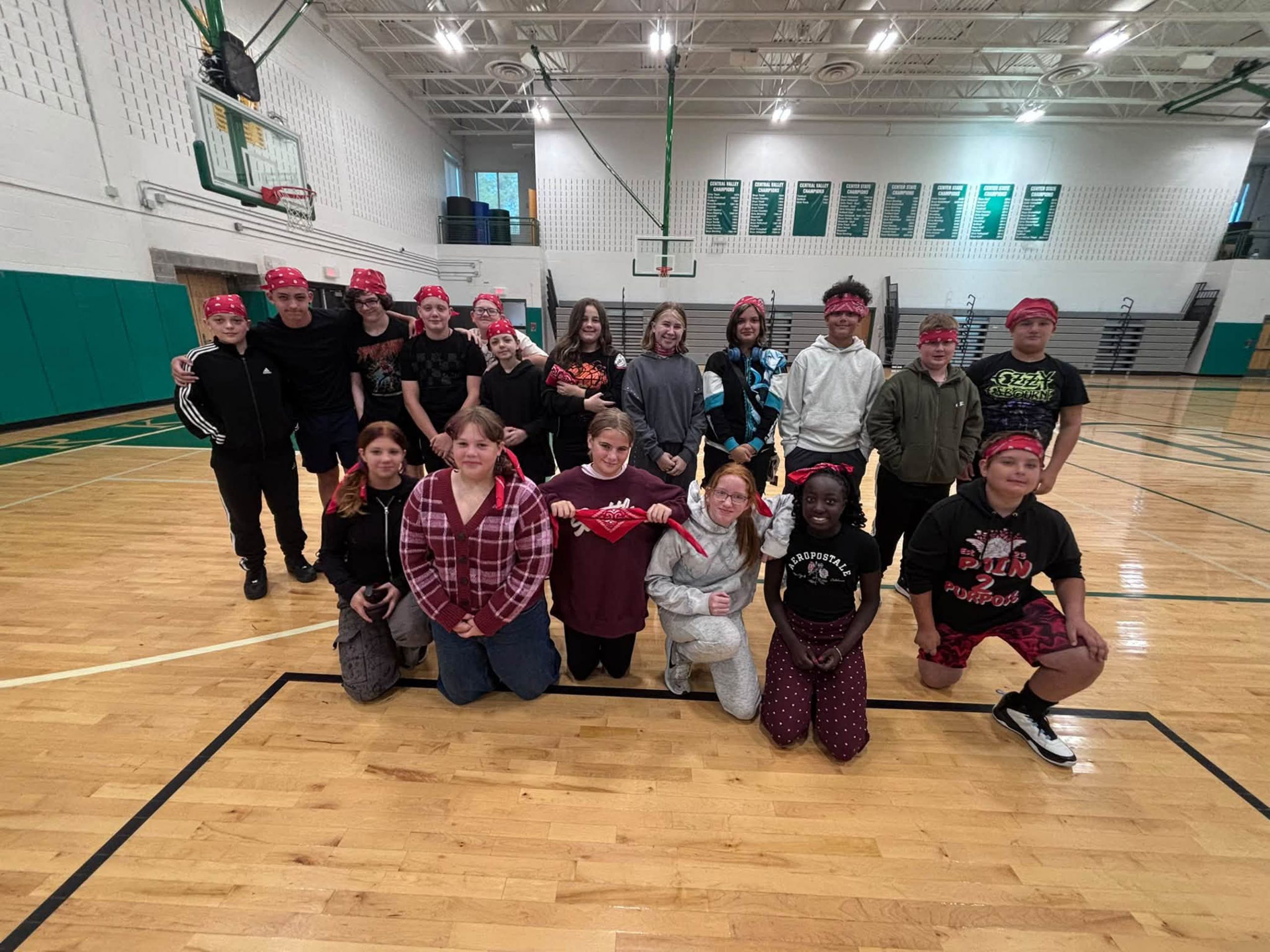 Students posing together in gym during Middle School Forum