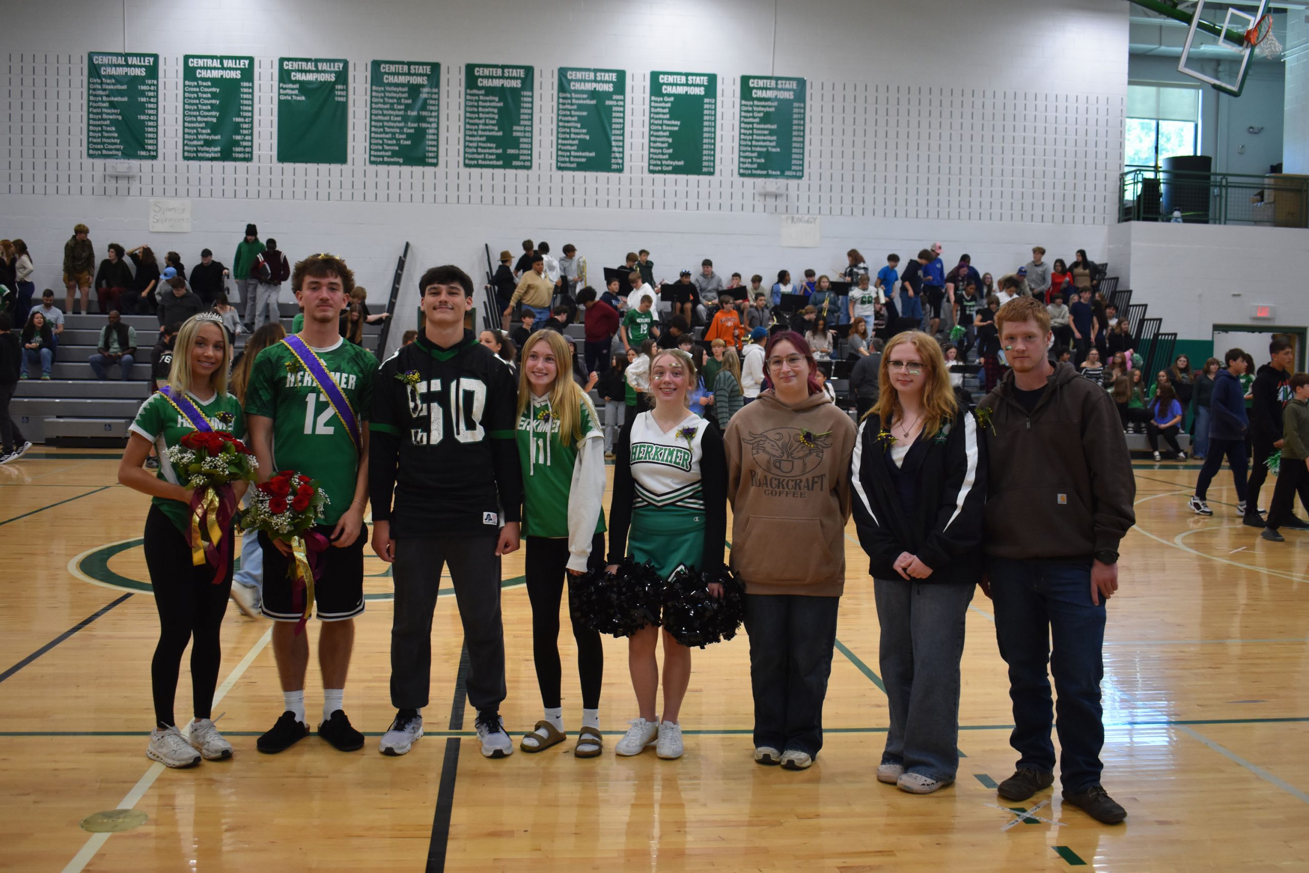 Homecoming court posing in gym